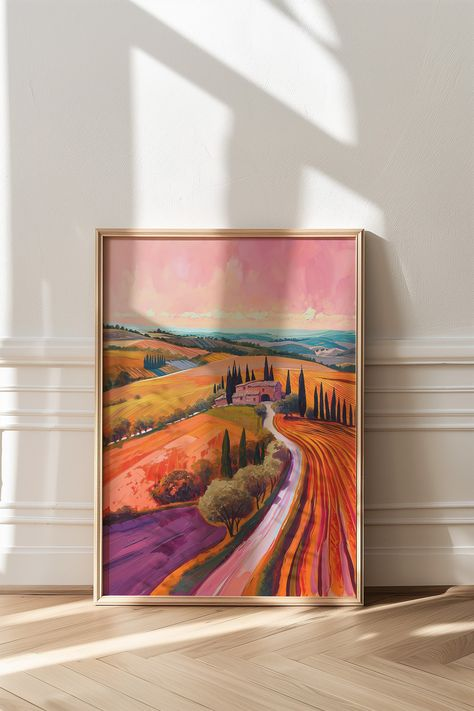 A colorful painting framed on the floor